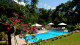 Pousada Bromélias -  Cercada por muita natureza, a refrescante piscina com cascata é um convite para relaxar e pegar um bronze! 