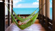 Windtown Beach Resort e SPA - Relaxe com uma boa leitura enquanto descansa nas redes da varanda do seu quarto.
